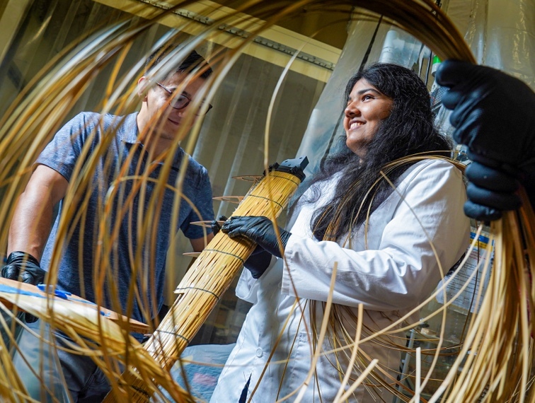 Three researchers assemble wind turbines made out of bamboo.